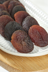Xinjiang Dried Candied Apricots Showcase - Black and Orange Preserved Fruits in Bowl