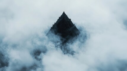 A dark, triangular mountain peak emerges from a thick layer of clouds.