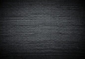 Close up textured dark grey fabric background with subtle woven pattern and vignette effect creating a moody and sophisticated backdrop for design projects