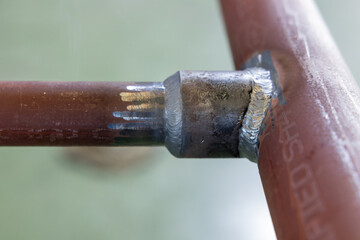 Close-up of welded metal pipe joint