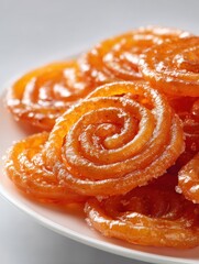 Fototapeta premium close up of jalebi a sweet dish from india on a white plate studio shot traditional dessert food photography