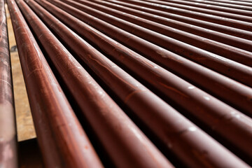 Stack of metal pipes with beveled ends