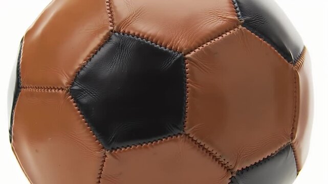 Close Up of Brown and Black Leather Soccer Ball Isolated on White Background