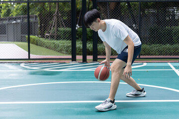 Focused Basketball Player Dribbling on Court