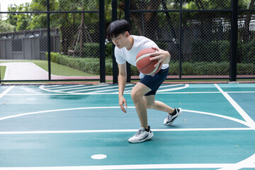 Focused Basketball Player Dribbling on Court
