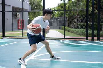 Focused Basketball Player Dribbling on Court