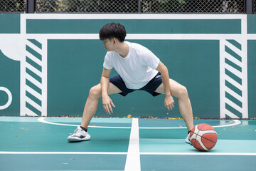 Young Athlete Stretching on Outdoor Basketball Court