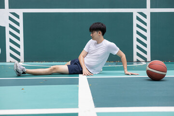 Young Athlete Stretching on Outdoor Basketball Court
