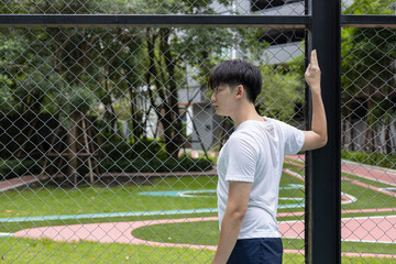 Young Athlete Stretching on Outdoor Basketball Court