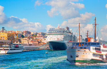 Cruise ship and ferry (steamboat) traffic in the Bosphorus - Sea voyage with old ferry (steamboat) on the Bosporus - Coastal cityscape with modern buildings under cloudy sky - Istanbul, Turkey