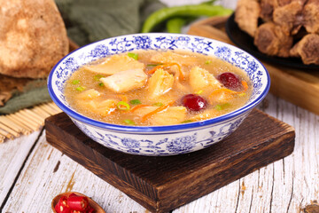 Nutritious Chinese Mushroom Soup with Wolfberries and Dates in Traditional Porcelain Bowl