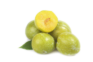 Fresh Green Plums Cut in Half Showing Yellow Flesh Studio Shot