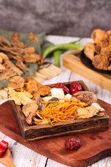 Traditional Chinese Herbal Soup Ingredients with Dried Mushrooms Red Dates and Wolfberries on Wooden Board