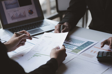 coworkers analyzing charts and data in an office