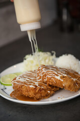 Pouring Rich Tonkatsu Sauce over Crispy Fried Pork Cutlets