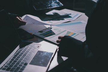 Group of business women working on a financial data expenses document.