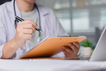 Doctor hand writing medical report on clipboard hospital office. Physician checking patient chart diagnosis using pen. Healthcare professional insurance prescription concept.