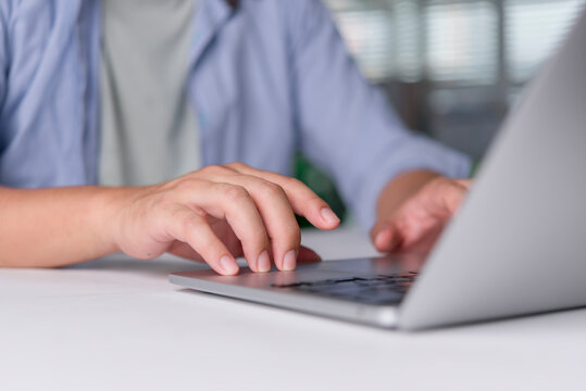 Person using touchpad laptop browsing web content website. Student learning education course online research information. Modern programmer coding software job occupation.