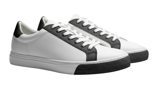 Pair of white leather sneakers with black accents isolated on transparent background