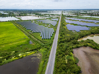 Aerial view drone shot scenic landscape of a road passing through a solar farm in Thailand