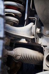 The suspension of a four-wheel drive pickup truck that has been used for rough use