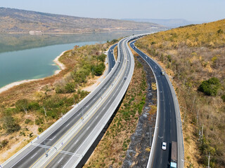 Drone shot aerial view landscape of the M6  motorway Expressway Nakhon Ratchasima Province - Bang Pa-in. Lam Ta Khong River and Mountain. Drone shot of scenic landscape rural place traffic