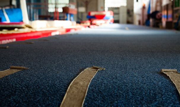 Interior of gym with old exercise machines, parallel bars and pommel horse