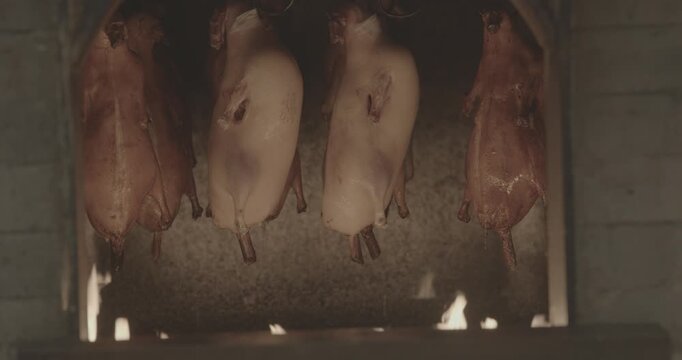 Hanging Roasted Ducks in a Traditional Cooking Setup