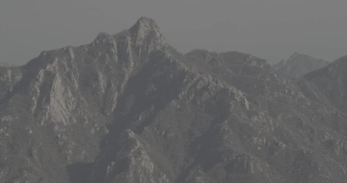 Rugged peaks towering over serene valleys and historic remnants