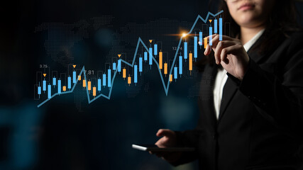 A businesswoman analyzes stock market trends using digital graphs in a modern office. The image reflects the intersection of finance and technology in today economy. Gantry