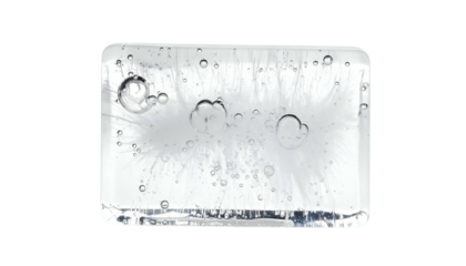 Close-up of a translucent ice cube with trapped air bubbles and feathery internal structures