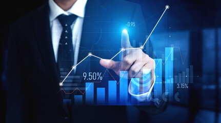 A businessman in a suit interacts with a touchscreen interface displaying data trends and financial graphs in a modern office setting, symbolizing digital innovation. Scalp