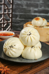 Steamed Chinese Buns with Sesame Seeds - Traditional Asian Breakfast Dumplings on Dark Plate