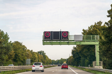 Speed limit restriction on Autobahn showing 120 km/h, cars moving along at speed in Deutschland