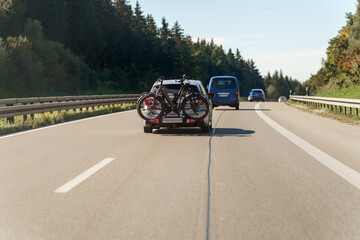Going on an adventure trip with bicycles driving on a German Autobahn under the clear blue sky
