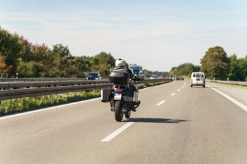 Riding through bavaria on a bright day with clear skies and other cars