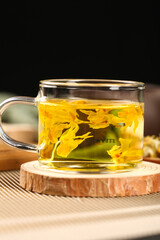 Dendrobium Flower Tea in Glass Cup with Wooden Coaster
