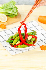 Traditional Chinese Stir-Fry with Bell Peppers and Chopsticks