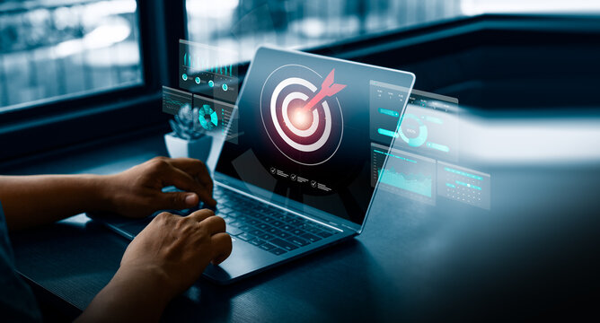 Digital target marketing and business goal strategy concept with person using laptop showing virtual target and analytics dashboard, symbolizing focus, achievement, and performance optimization