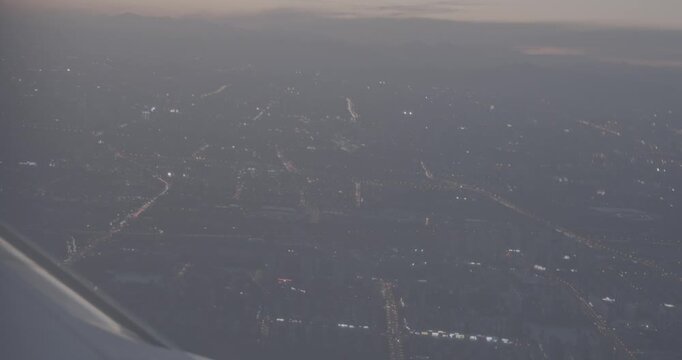 Illuminated City Lights at Dusk with Mountain Backdrop