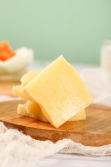 German Emmental Cheese Cubes with Holes on Wooden Board