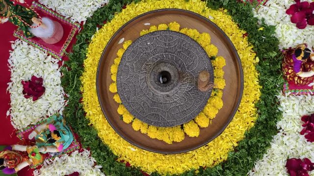 Group of Indian women holding a stone peace of mortar for making turmeric paste for wedding ceremony. Its a rituals of traditional Hindu wedding, Haldi ceremony