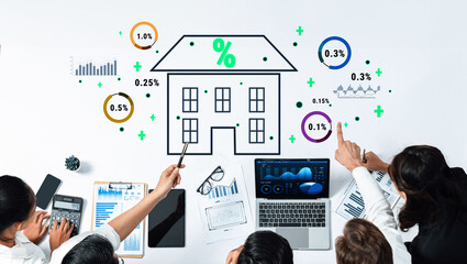 A diverse team engages in a strategic analysis of real estate investment data, showcasing various charts and graphs on a modern office desk to drive informed decisions. Trope