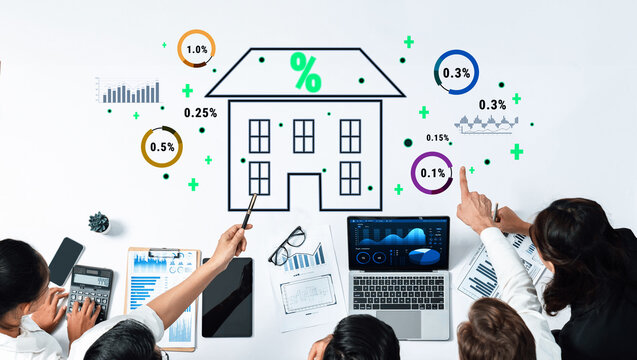 A diverse team engages in a strategic analysis of real estate investment data, showcasing various charts and graphs on a modern office desk to drive informed decisions. Trope - Powered by Adobe