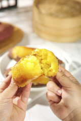 Golden Sweet Potato Steam Bun with Fluffy Yellow Interior Held in Hands - Traditional Asian Comfort Food