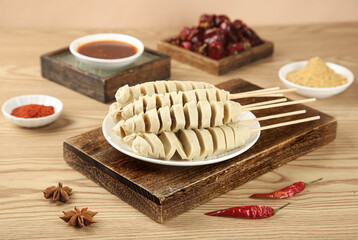Homemade Dumplings with Spicy Sauces and Skewers on Rustic Wooden Board - Traditional Asian Food