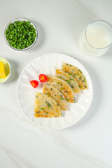 Shanghai Style Scallion Pancakes with Green Onions and Butter on White Marble Table