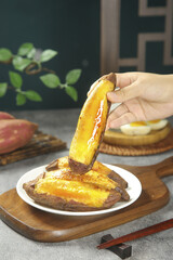 Japanese Sweet Potato with Honey Glaze - Traditional Asian Comfort Food Dessert on Wooden Plate