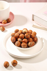 Fresh Handpeeled Hazelnuts in White Bowl - Natural Dry Nuts with Shells