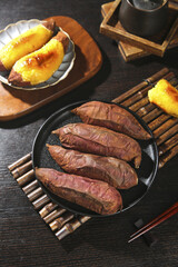 Japanese Sweet Potato Yaki Imo Traditional Roasted Kintoki Potato with Tea Setting on Rustic Wooden Table